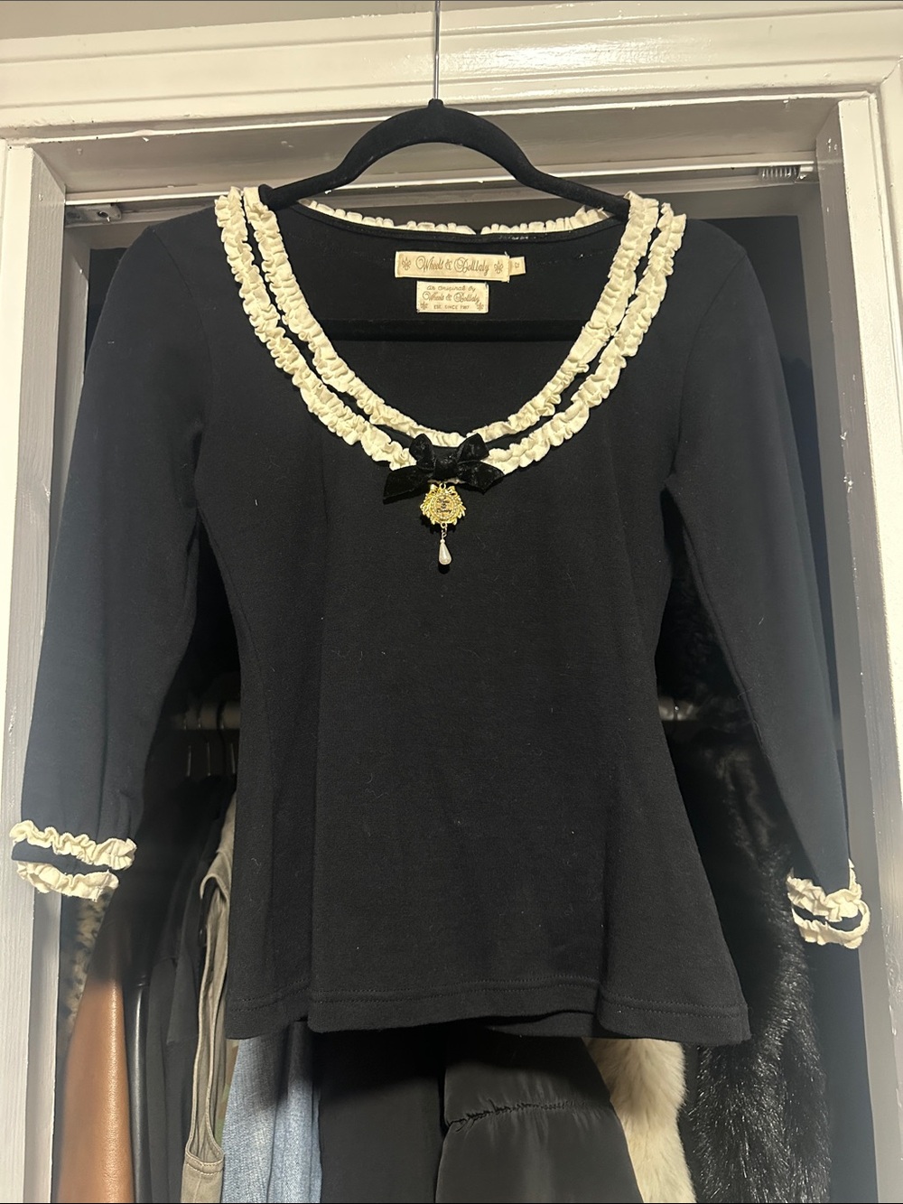 Wheels and Dollbaby -Black Long-Sleeve Top with Cream Ruffle Trim and Bow Brooch